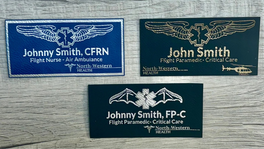 Custom leather EMS and air medical flight badges in blue/silver, black/gold, and black/silver with laser-engraved names, credentials, and aviation wing designs.